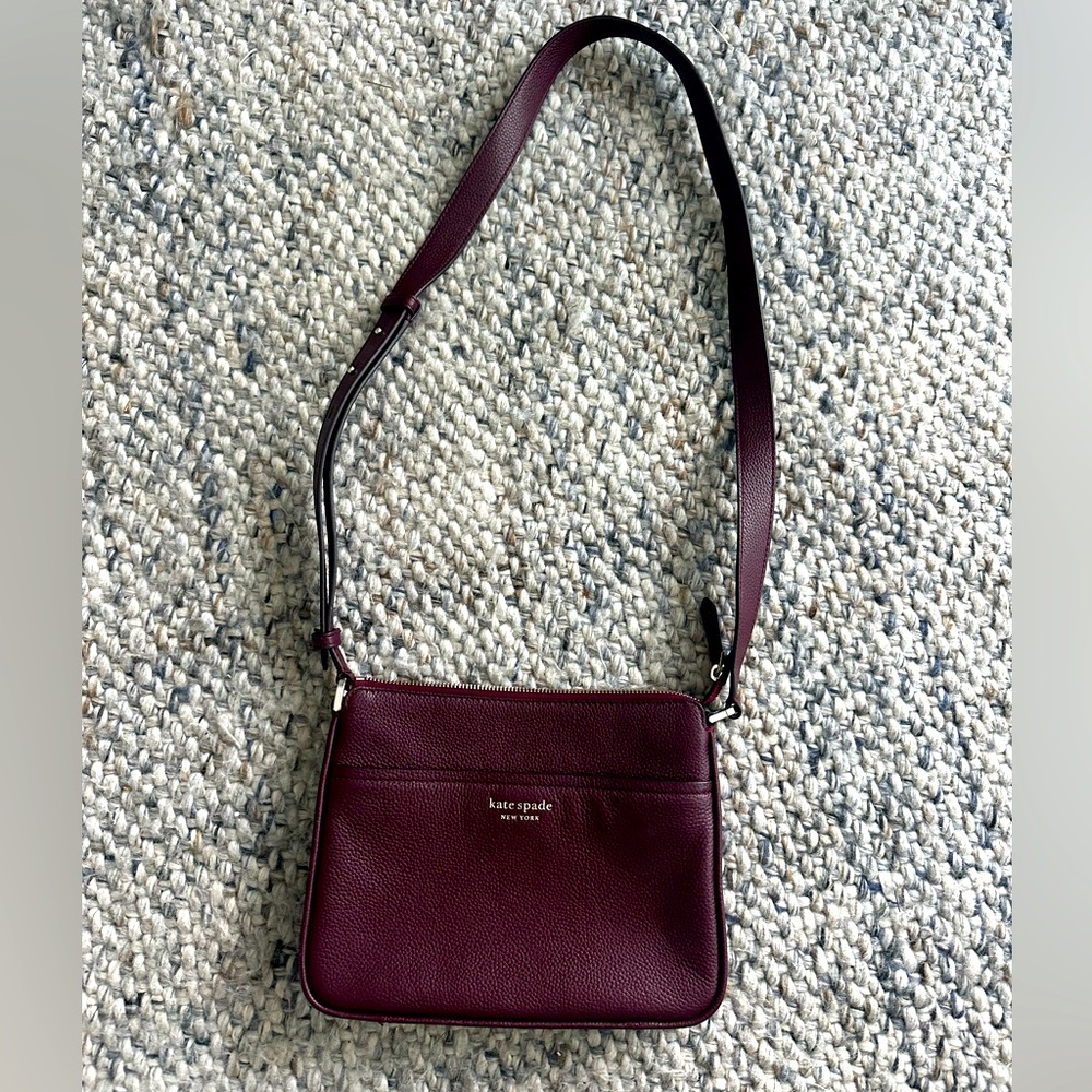 Burgundy Kate Spade Crossbody with leather strap and zipper